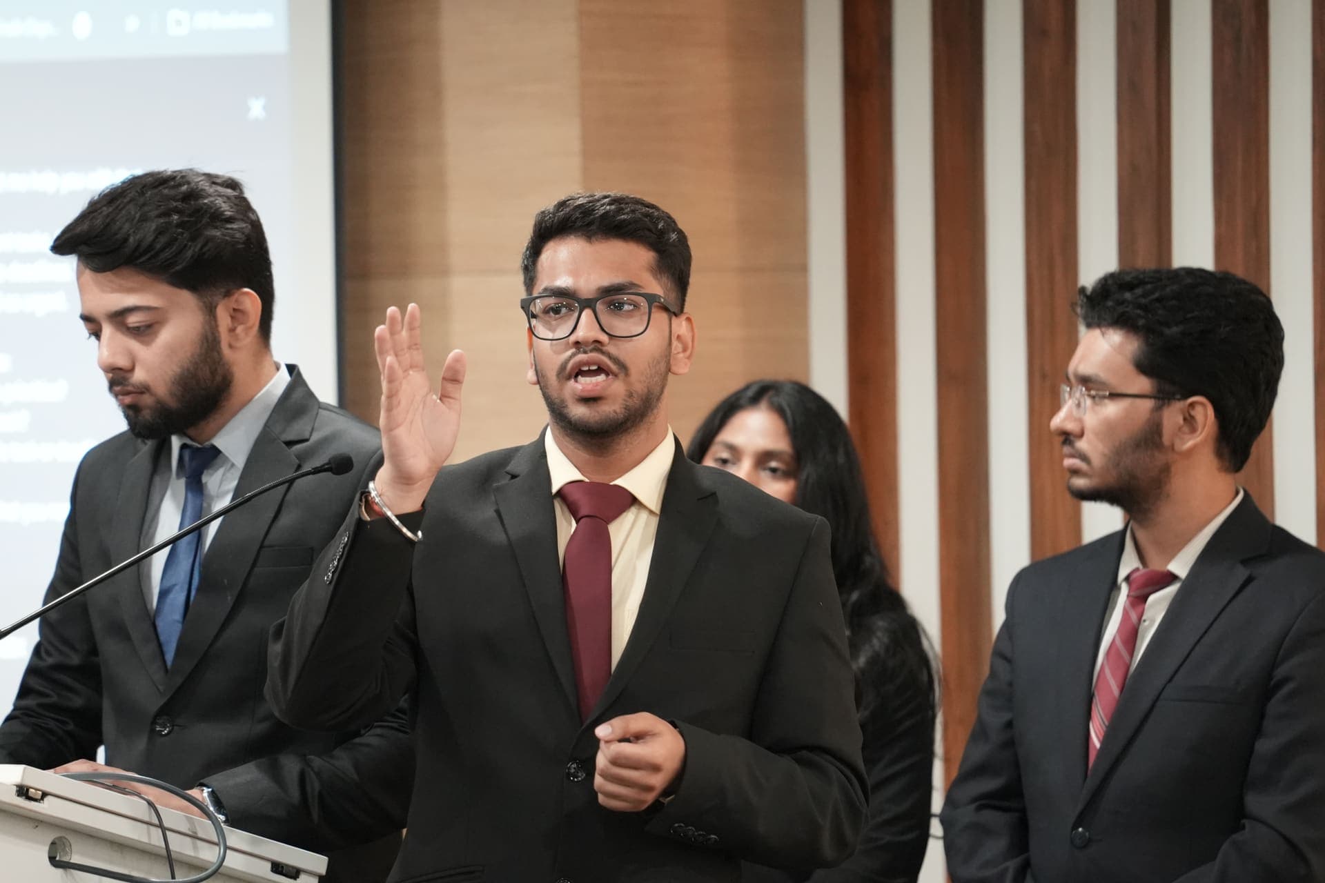 A student presenting at the podium during the AI Mini Hackathon final at Great Lakes Gurgaon