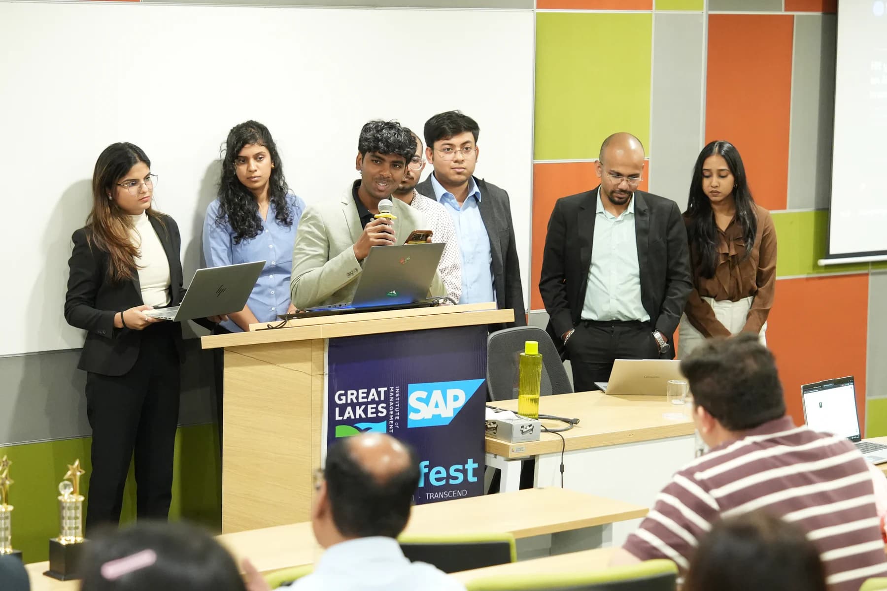 A student team presenting an AI prototype during a live hackathon pitch