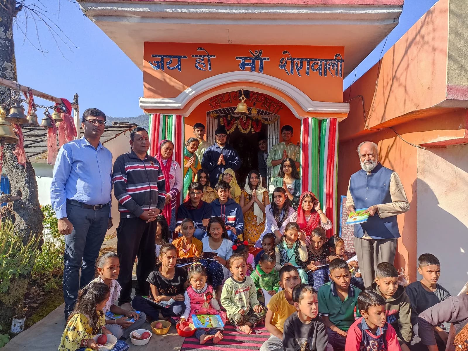 Prof. S. K. Palhan and Dr. Swapnil Sahoo with local families and children at a village shrine