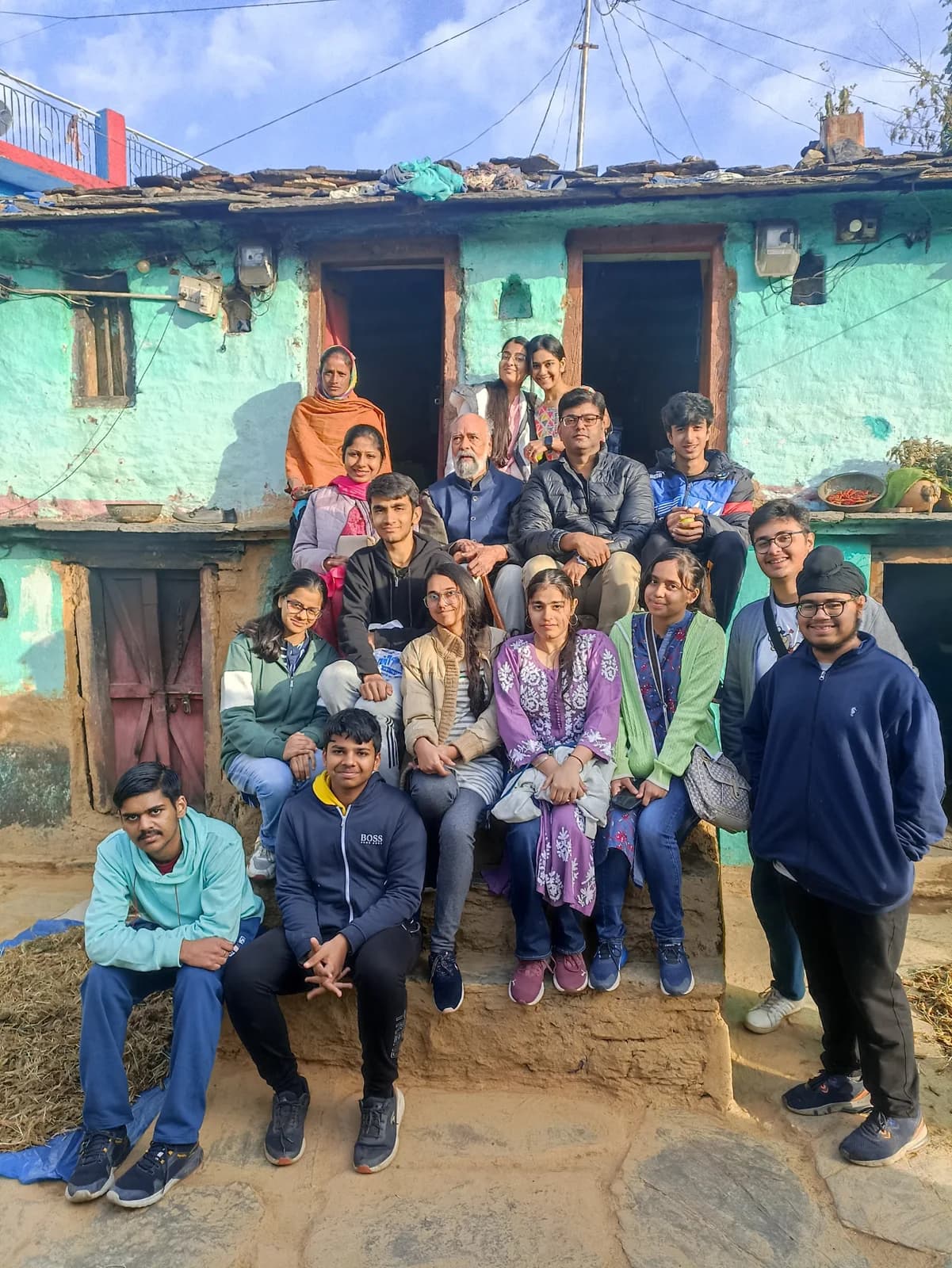 Great Lakes students gathered with a Mehalchauri family outside their home