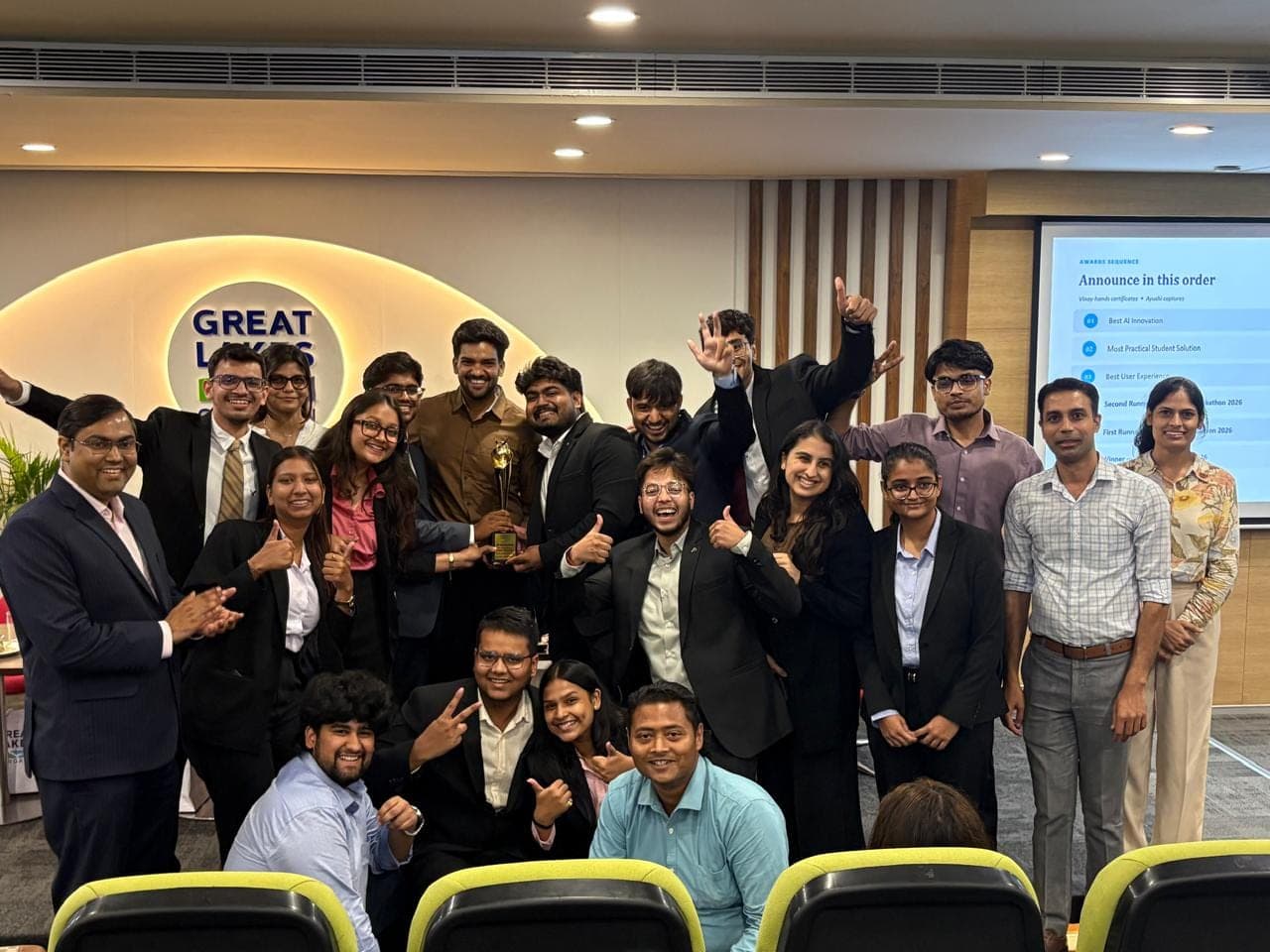 A student team celebrating with a trophy after a pitch competition at Great Lakes Gurgaon