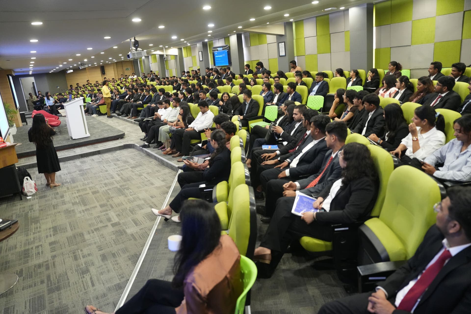 Dr Swapnil Sahoo speaking to a full auditorium during a PGDM induction session