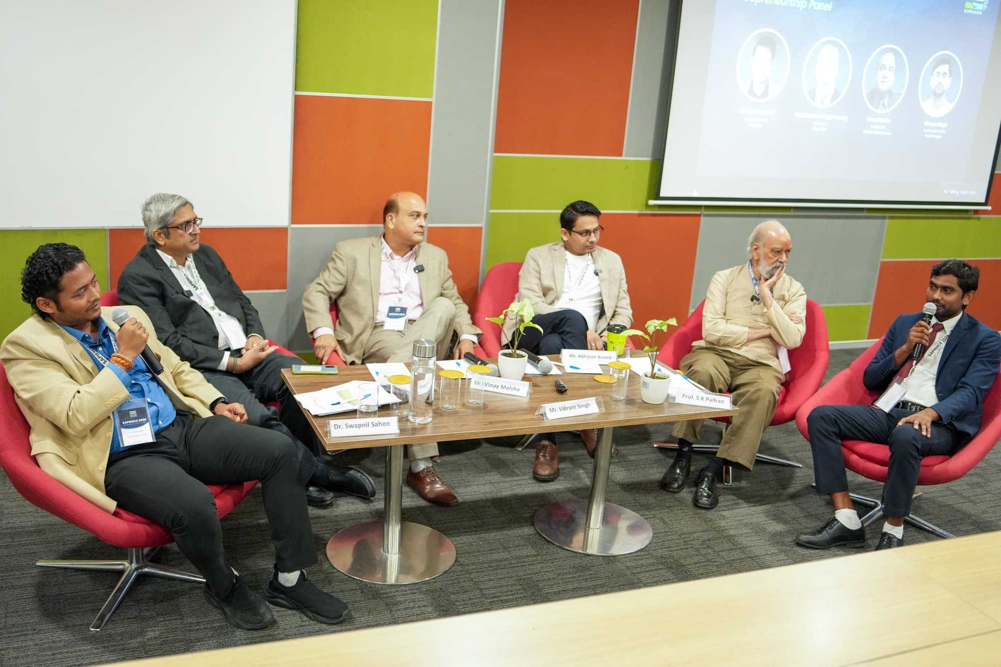 Swapnil Sahoo mid-speech on a panel at SAPIENCE 2025
