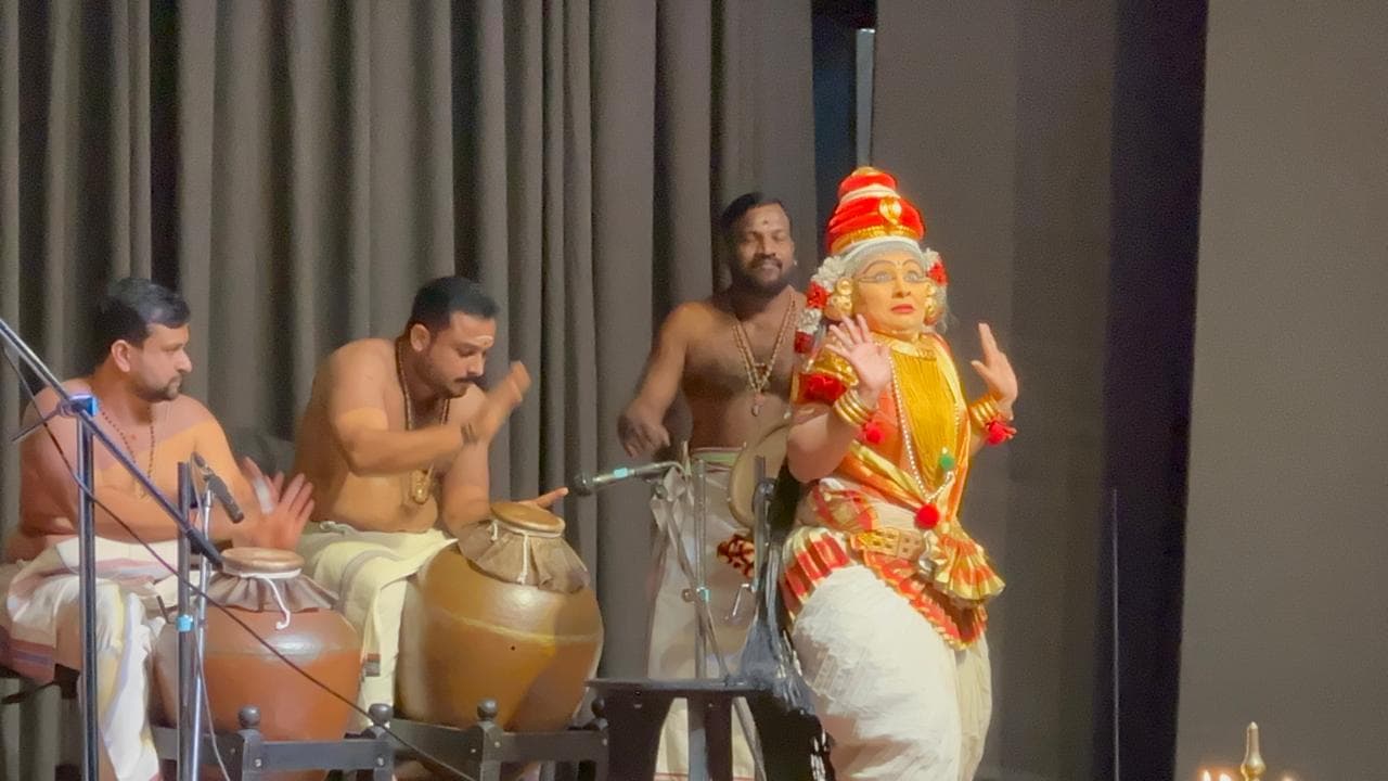 A Koodiyattam classical performer on stage with musicians, at a SPIC MACAY cultural evening