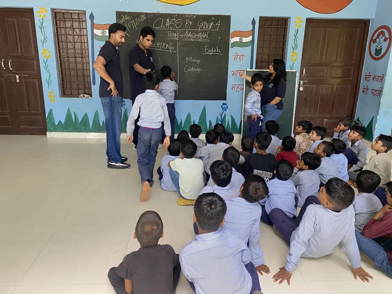 Management students leading a participatory classroom lesson with schoolchildren