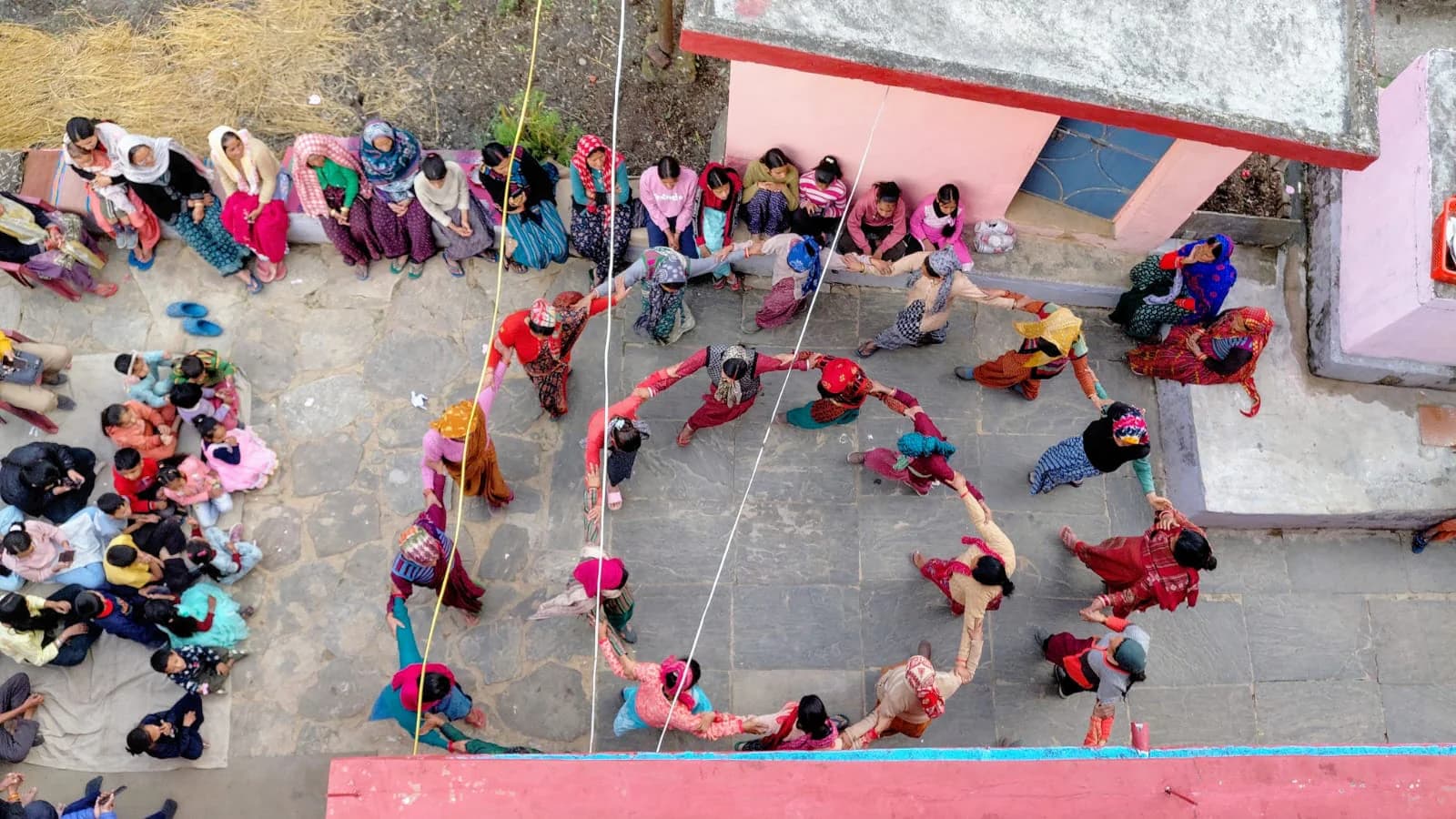 Women and girls forming a community circle in a Mehalchauri courtyard