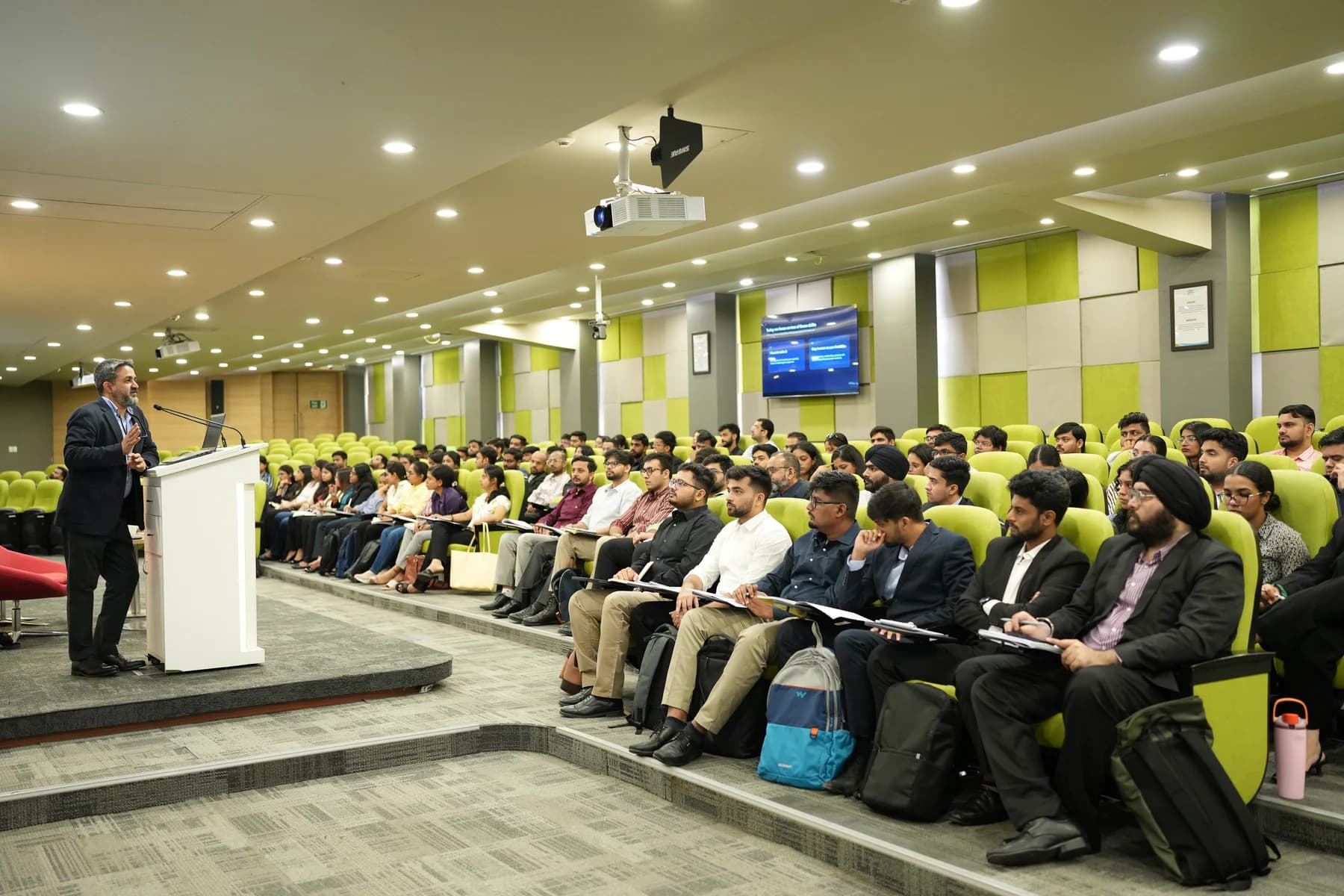 An intensive management classroom with learners gathered for a live strategic discussion