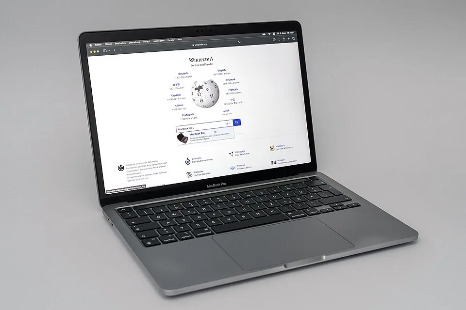 An open 13-inch M1 MacBook Pro on a desk.